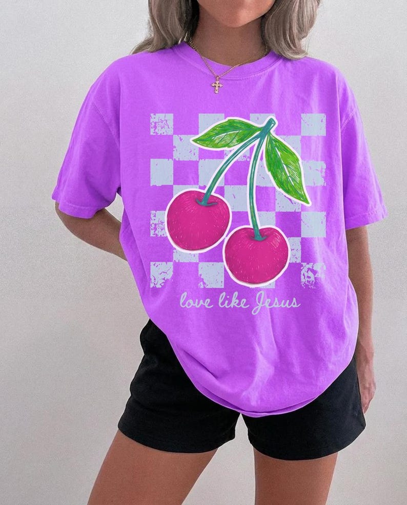 Trendy Christian shirt design with vibrant cherries and checkerboard accents.