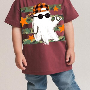 Kids spooky season shirt design with hand-drawn ghost and camo stripes