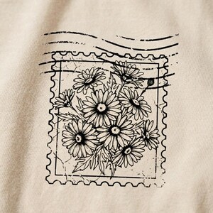 Faith inspired women’s shirt design with motherhood typography and sketched daisy floral artwork