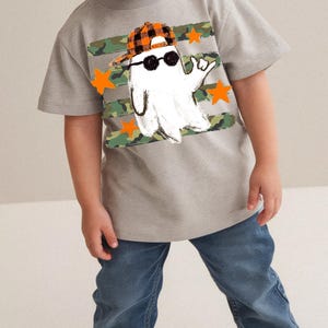 Ghost Halloween design with camouflage background and orange stars