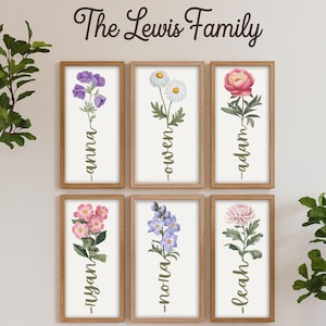 Puede incluir: Seis impresiones enmarcadas con ilustraciones florales y nombres escritos verticalmente debajo de cada flor. Los nombres son Anna, Owen, Adam, Ryan, Noah y Leah. El texto en la parte superior de las impresiones dice "The Lewis Family".
