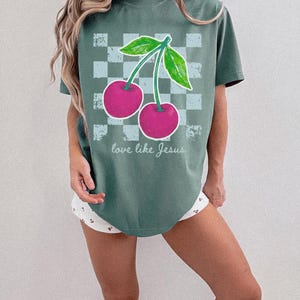Boutique Christian apparel design with cherries and trendy checkerboard pattern.