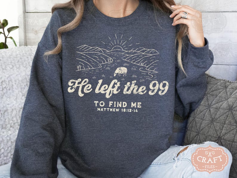May include: A dark blue sweatshirt with a white graphic design of a sheep in a field. The text "He left the 99 to find me Matthew 18:12-14" is printed on the sweatshirt.