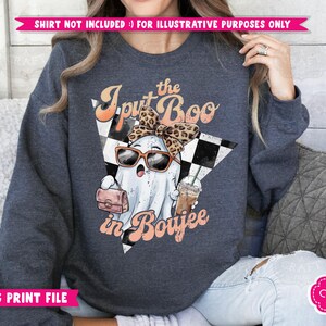 May include: A dark blue sweatshirt with a graphic of a ghost wearing a leopard print headband and sunglasses, holding a purse and a coffee cup. The text "I put the Boo in Boujee" is printed on the sweatshirt.