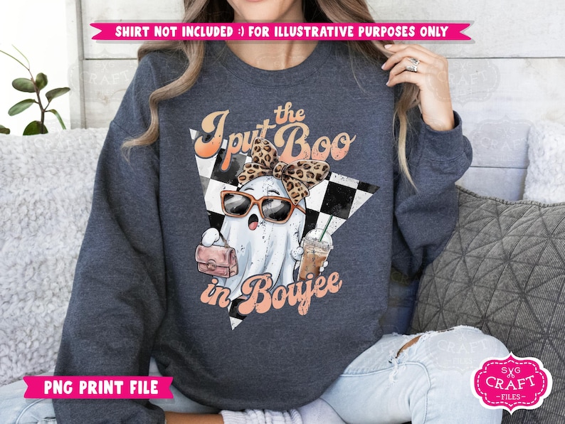 May include: A dark blue sweatshirt with a graphic of a ghost wearing a leopard print headband and sunglasses, holding a purse and a coffee cup. The text "I put the Boo in Boujee" is printed on the sweatshirt.