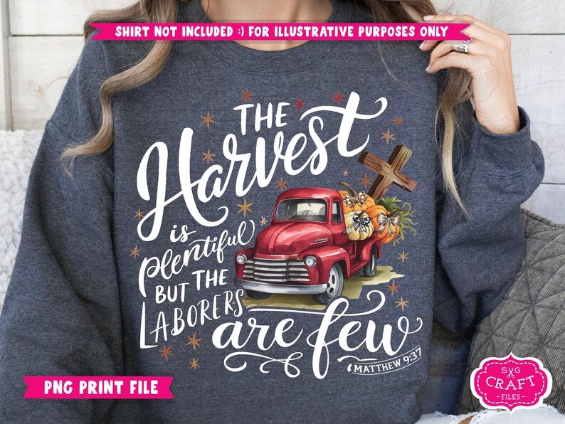 May include: A dark blue sweatshirt with a white graphic design featuring a red truck carrying pumpkins and a cross. The text reads "The Harvest is Plentiful But The Laborers Are Few" with the scripture reference "Matthew 9:37".