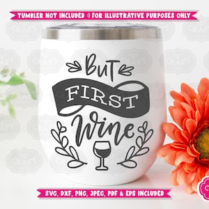 May include: White stemless wine tumbler with the phrase "But First Wine" in black script. The design includes a banner, leaves, and a wine glass. The image also includes a bright orange flower and text that says "Tumbler not included".
