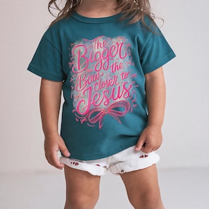 Faith-inspired girls t-shirt design with bow graphic