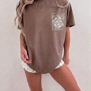Retro motherhood faith shirt graphic featuring hand drawn flowers and Christian typography for women