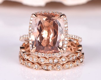 May include: A rose gold engagement ring set with a large cushion-cut morganite center stone surrounded by a halo of smaller diamonds. The ring is paired with two matching bands, each featuring a delicate diamond design.