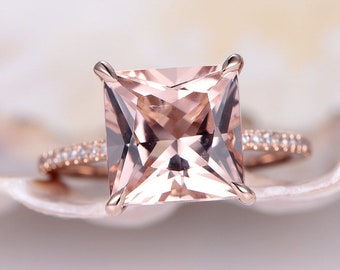 May include: A rose gold engagement ring with a large square-shaped morganite gemstone and a diamond halo setting.
