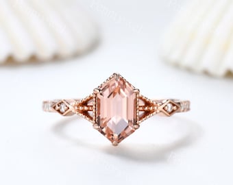 May include: A rose gold engagement ring featuring a hexagonal morganite gemstone and a delicate diamond-studded band.