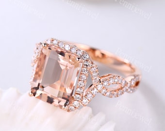 May include: A rose gold engagement ring with a large, square-cut morganite center stone surrounded by a halo of smaller diamonds. The band is a delicate, twisted design with pave diamonds.