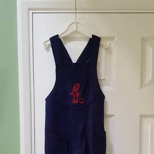 Vintage unworn dead stock 1970s children’s navy blue dungarees overalls with red motif