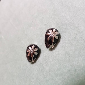 Vintage 1970s clip-on earrings in black, silver and diamante flower design