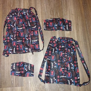 May include: A set of Spider-Man themed drawstring bags and face masks. The items are black with a repeating pattern of Spider-Man's face, the words "Spider-Man" and "Web Slinger" in red, blue, and white.