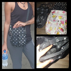 May include: A woman is wearing a black tank top and black pants. She is carrying a black and white star patterned crossbody bag with a silver zipper. The bag has the word "Dynae" on the front.