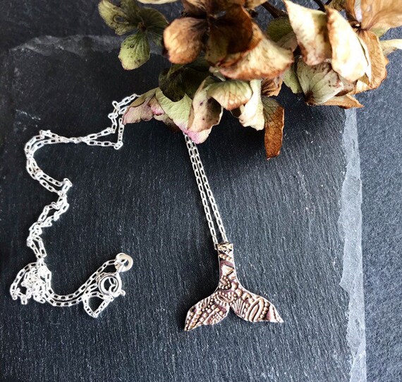 A Handmade fine silver whales tail necklace.