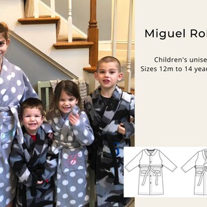May include: Four children wearing grey and camouflage robes with white polka dots. The robes have a tie belt and pockets. The text "Miguel Robe" and "Children's unisex Sizes 12m to 14 years old" is visible in the image. Two line drawings of the robe are also shown.