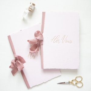Pink handmade paper book with tan letterpress ink
