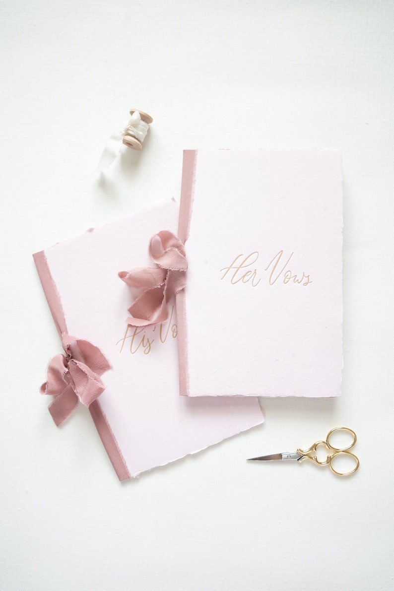 Pink handmade paper book with tan letterpress ink