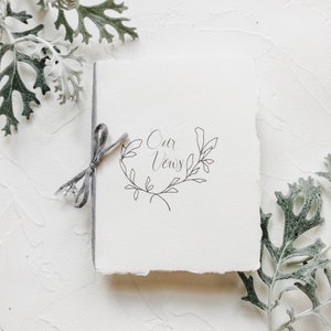 Smaller Wedding Vow Book on Handmade Paper with Cotton Ribbon Flat Lay Styling OUR Vine Wreath