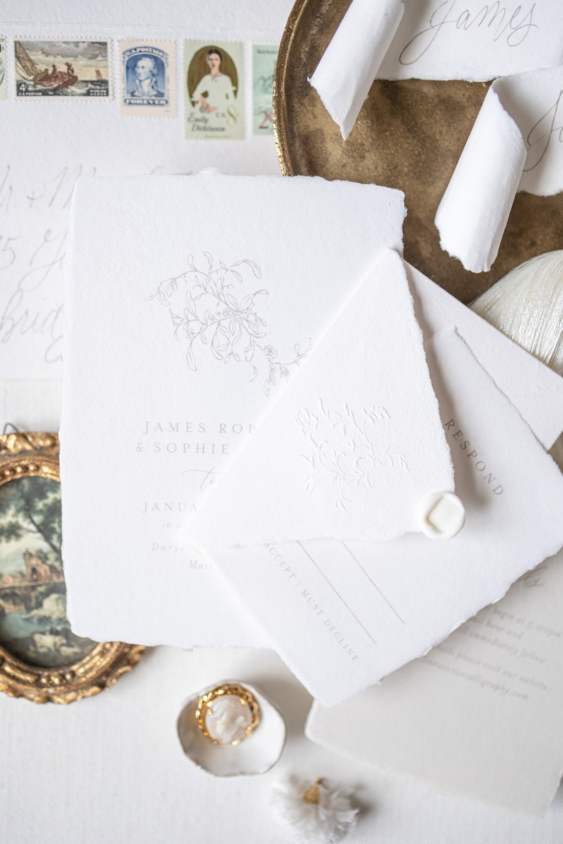 May include: A white wedding invitation with a floral design and the text "JAMES ROP & SOPHIE to JANUA in Darze, Ma. ACCEPT MUST DECLINE RESPOND".