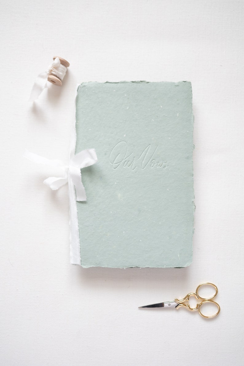 Green handmade paper book with blind (no) letterpress ink