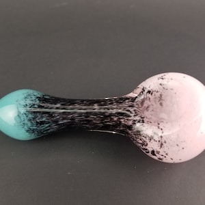Glass pipe with teal, black, and pink