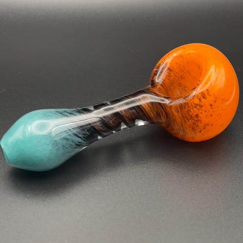 Twisted spiral glass pipe with teal, black, and orange