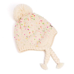 May include: Cream-colored knit hat with a large pom-pom and colorful flecks. The hat features ear flaps with braided tassels. A cozy winter accessory.