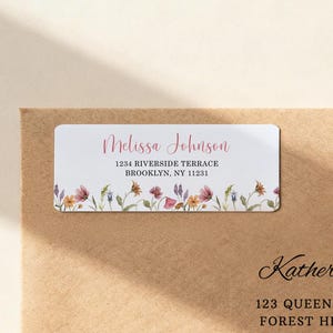 May include: A rectangular address label with the name "Melissa Johnson" in a cursive font. The label includes the address "1234 Riverside Terrace, Brooklyn, NY 11231" and a floral border with watercolor-style flowers.