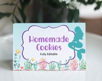 May include: A rectangular card with the text "Homemade Cookies" in purple, framed by a decorative border. A teal mermaid silhouette is on the right. The card has an underwater theme with coral and seaweed illustrations.