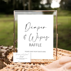May include: A gold-framed sign with the text "Diaper & Wipes Raffle" and instructions to leave tickets. A smaller card with the text "Diaper and Wipes Raffle" and instructions to bring a pack of diapers or wipes for a chance to win a special prize.