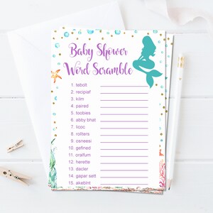 May include: A printable baby shower game with a mermaid illustration and a list of 15 words to unscramble. The words are related to the ocean and babies. The game is printed on white paper with a purple border and gold glitter accents.