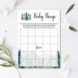 May include: A printable baby bingo card with a watercolor background of a forest scene. The card has a 5x5 grid with squares for players to fill in with gifts they think the mom-to-be will receive. The card also has the text "Baby Bingo" and "free" in the center square.
