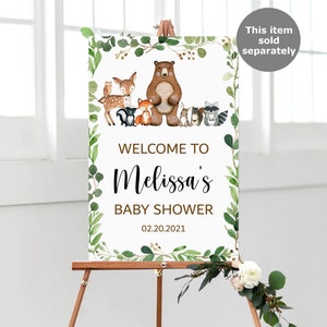 May include: Welcome to Melissa's Baby Shower sign with a woodland theme. The sign features a brown bear, a deer, a fox, a raccoon, and other woodland animals surrounded by green leaves. The date of the shower is 02.20.2021.