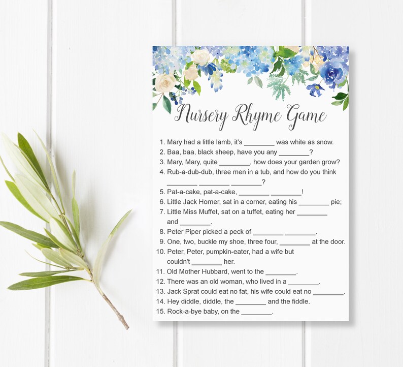 May include: A printable Nursery Rhyme Game card with a floral design in blue and white. The game features fill-in-the-blank nursery rhyme questions. A sprig of greenery is on the left side of the card.