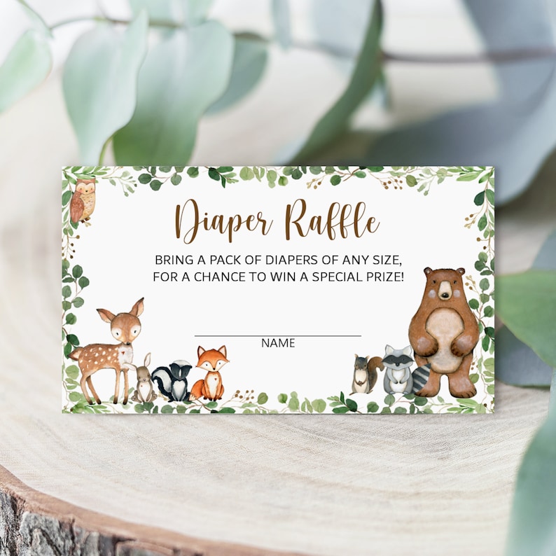 May include: A green and brown diaper raffle ticket with a woodland theme. The ticket features a deer, fox, owl, raccoon, squirrel, and bear. The text on the ticket reads "Diaper Raffle" and "Bring a pack of diapers of any size, for a chance to win a special prize!" There is a blank line for a name.