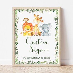 May include: A printable sign with a green leafy border featuring a lion, giraffe, monkey, and elephant. The sign says "Custom Sign" and "We customize, you print".