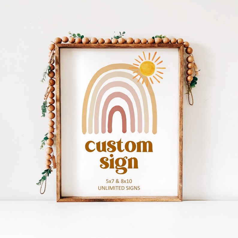 May include: A digital print with a rainbow and sun design. The rainbow is in shades of pink, orange, and yellow. The sun is yellow. The text below the rainbow reads 'custom sign' in brown text. The text below the sign reads '5x7 & 8x10 UNLIMITED SIGNS'.
