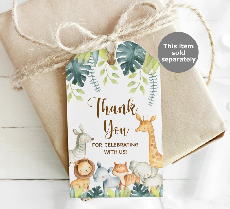 May include: Thank you tag with a jungle theme. The tag features a giraffe, zebra, lion, rhino, and tiger surrounded by green leaves. The text on the tag reads "Thank You for celebrating with us!"