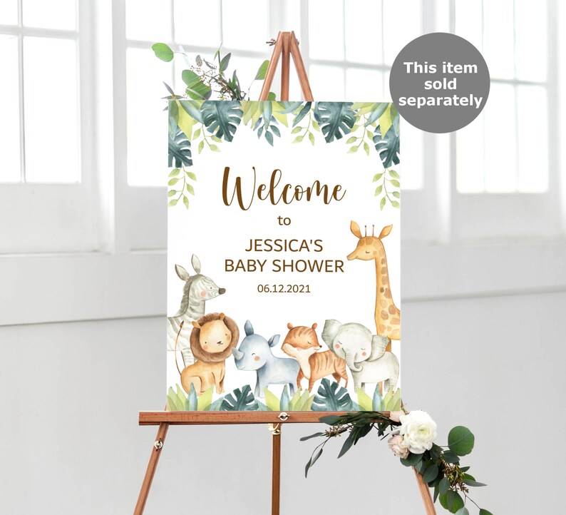 May include: Welcome to Jessica's Baby Shower sign with a jungle theme. The sign features a giraffe, zebra, lion, rhino, tiger, and elephant with green leaves and a white background. The date of the shower is 06.12.2021.