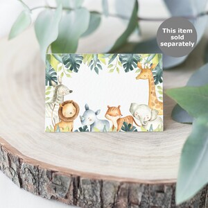 May include: A rectangular card with a jungle-themed design. The card features watercolor illustrations of various animals, including a zebra, lion, rhino, tiger, elephant, and giraffe, surrounded by green leaves. The text "This item sold separately" is in a gray circle.