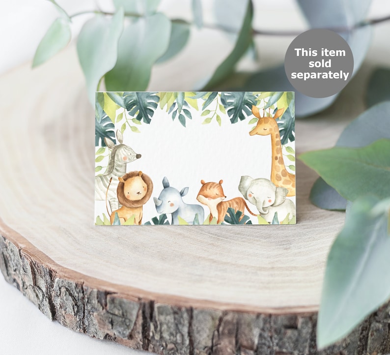 May include: A rectangular card with a jungle-themed design. The card features watercolor illustrations of various animals, including a zebra, lion, rhino, tiger, elephant, and giraffe, surrounded by green leaves. The text "This item sold separately" is in a gray circle.
