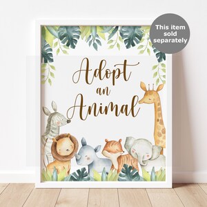 May include: A framed print with the words "Adopt an Animal" in brown script. The print features watercolor illustrations of a zebra, lion, rhino, tiger, elephant, and giraffe, surrounded by green foliage.