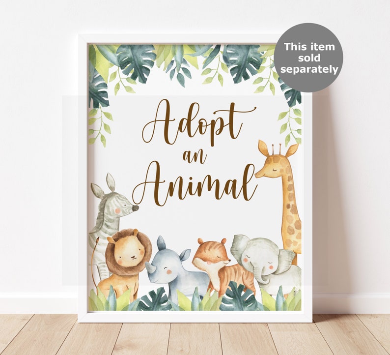 May include: A framed print with the words "Adopt an Animal" in brown script. The print features watercolor illustrations of a zebra, lion, rhino, tiger, elephant, and giraffe, surrounded by green foliage.