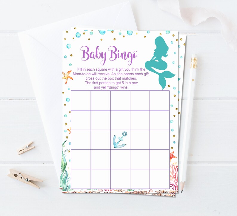 May include: A printable baby shower bingo card with a mermaid illustration and a purple and gold design. The card has a grid with squares to fill in with gifts the mom-to-be will receive. The text reads "Baby Bingo" and includes instructions for playing the game.