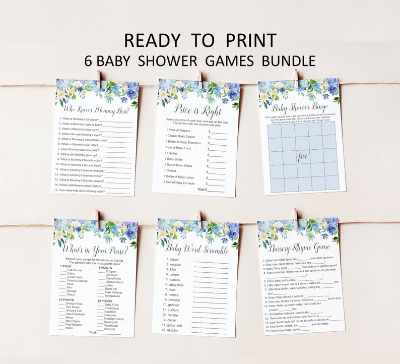 May include: A bundle of six printable baby shower games, including "Who Knows Mommy Best?" and "Baby Shower Bingo." Each game card features a floral design with blue and white accents and is held by a wooden clip.