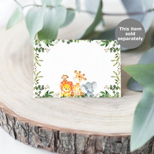 May include: A blank white card with a green leafy border. The card features a watercolor illustration of a lion, giraffe, and elephant. The text "This item sold separately" is in the top right corner of the image.